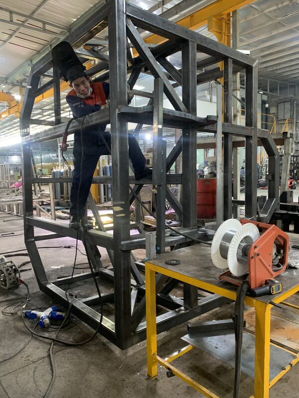 Welding a large structural steel frame in the workshop